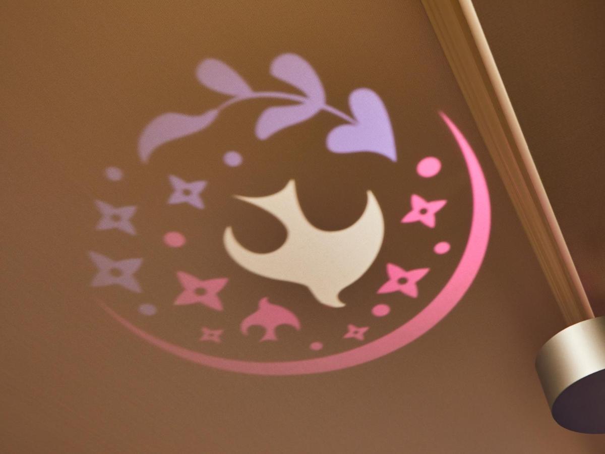 Grand Nikko Tokyo Bay Maihama Hotel Urayasu Eksteriør billede The image shows a projection on a surface, featuring a circular design with a mix of colors, primarily pink and purple. The design includes a white dove, which is likely a symbol of peace, surrounded by decorative elements such as leaves and small st
